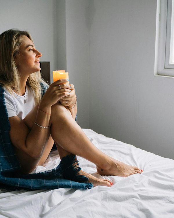 A person meditating peacefully by a window with morning light.