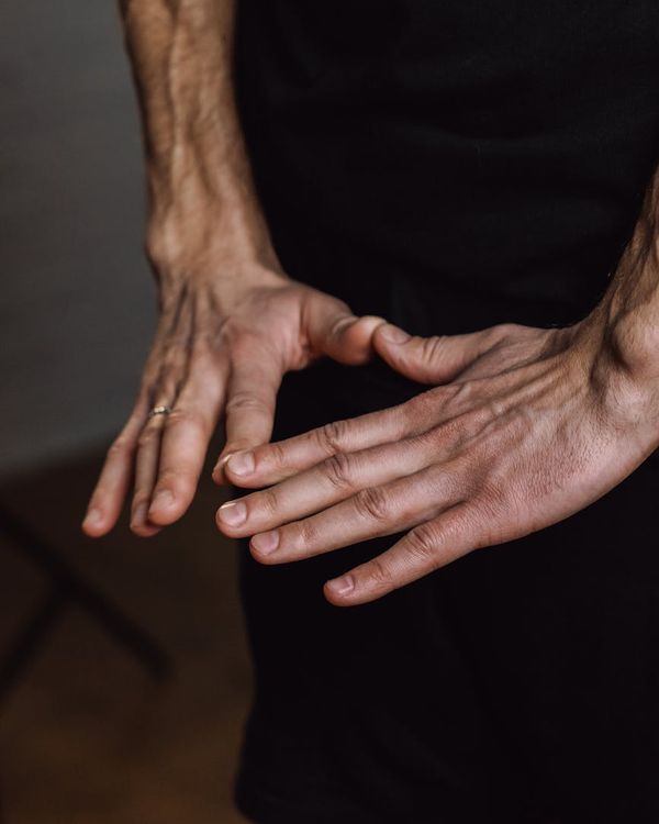 Close-up of a person's hands in a mudra gesture.